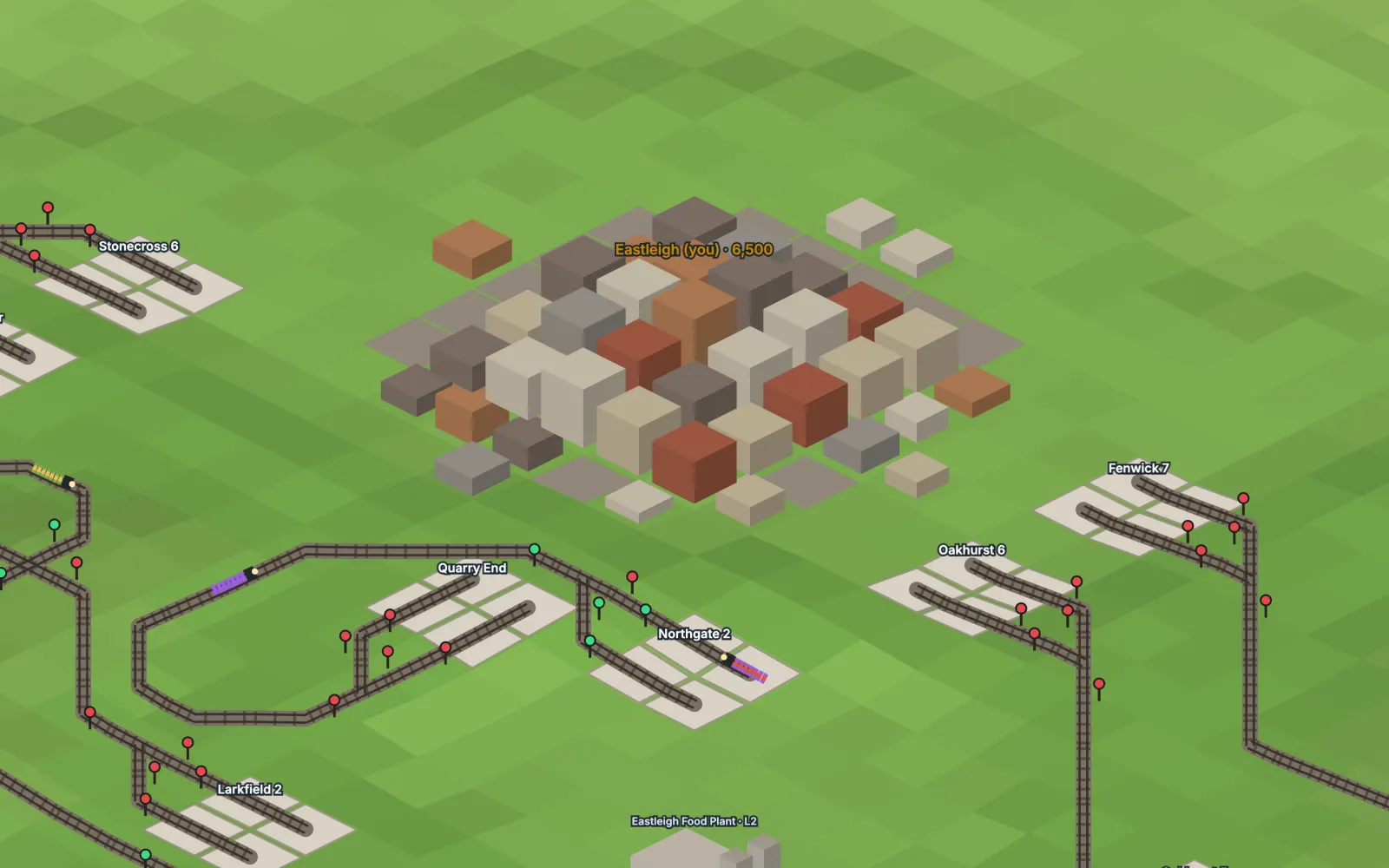 Close-up of a home city: stacked isometric buildings beside stations, signals and trains.